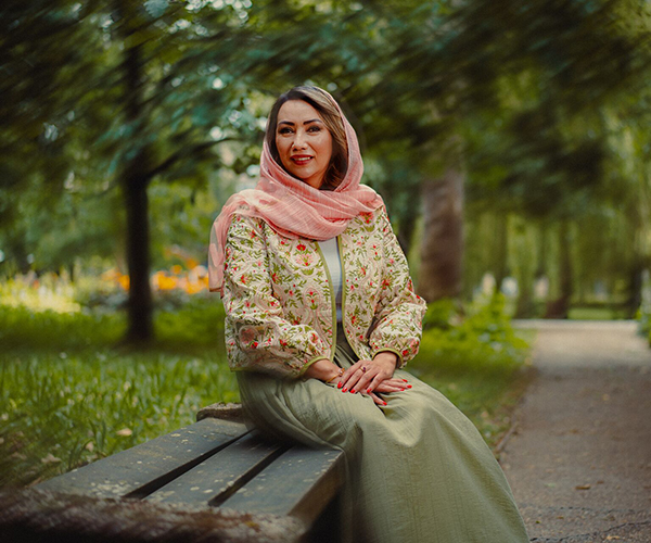 a york sanctuary fund scholar recipient sat on a bench on a university campus